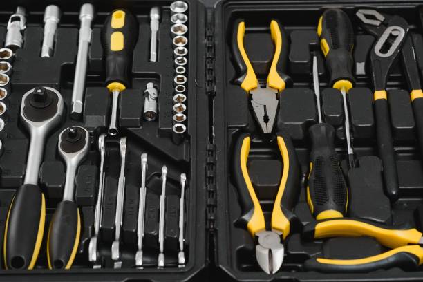 istock Yellow and black handy tools (pilers and screwdriver) isolated on yellow background. 1453152988