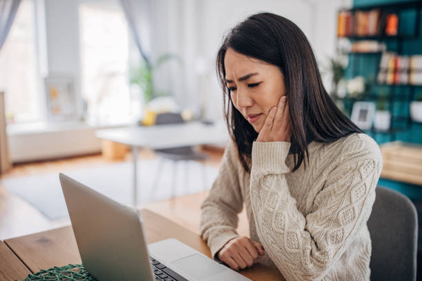 istock Woman has a toothache 1453154453