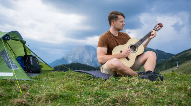 istock Young Man Camping In Mountains 1453156095