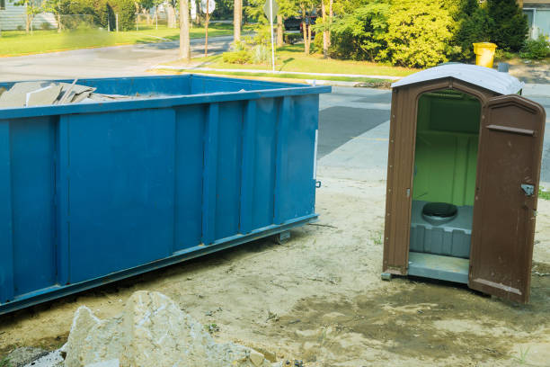 istock Construction garbage dumpster and portable restroom on new house under construction 1453157576