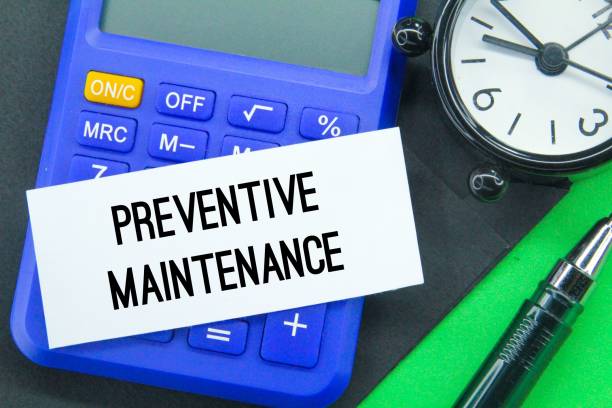 taschenrechner, wecker, stift und whitepaper mit dem wort vorbeugende wartung - preventative maintenance stock-fotos und bilder