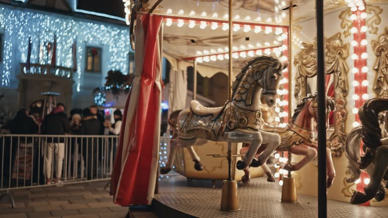 A lonely carousel with horses without people on it