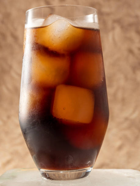 istock Cola with ice in a glass. Carbonated refreshing drink with ice. Cola bubbles. 1453158924