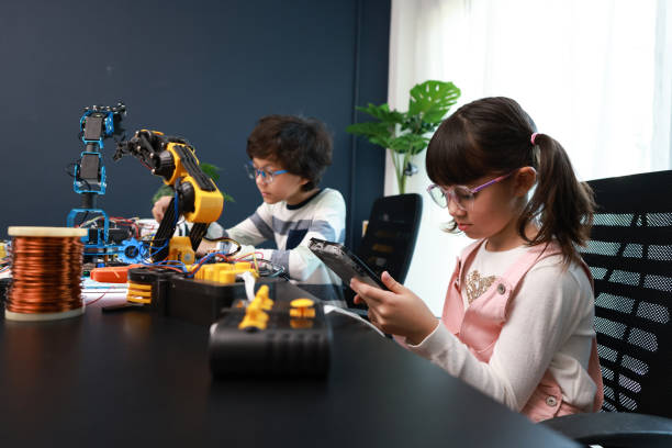 istock Science technology class, Robotics and education,school children students build robotic, and programing control the Robot arm. 1453159248