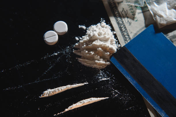 istock Hard drugs on black table. Close up. 1453160434