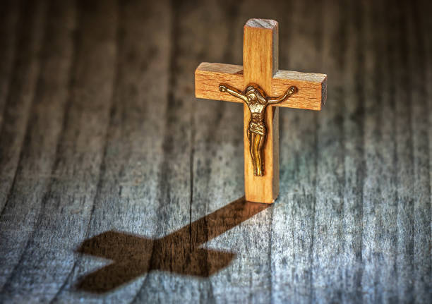 holly wooden Christian cross with shadow