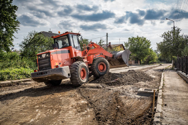 The loader is leveling the foundation for the new road at the construction site