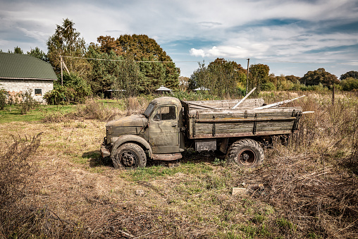 Wreck of old vintage truck standing on the field