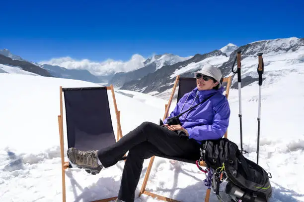 Mature woman relaxing after hiking the Glaciers of the Swiss alps in Jungfrau region