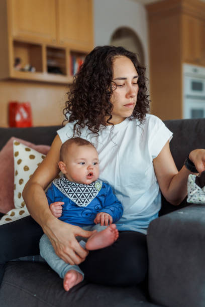 istock Mom trimming baby son's fingernails 1453172601