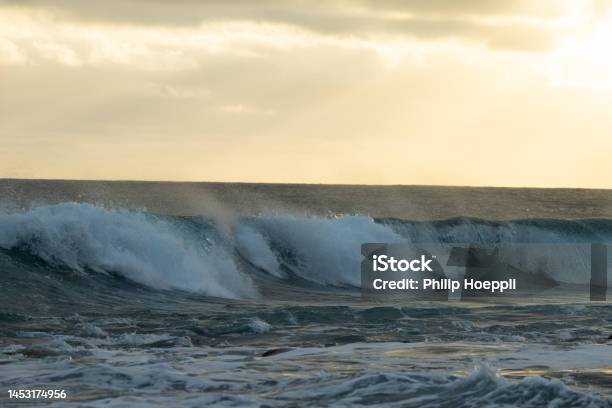 Huge Waves On A Beautiful Morning In Madeira Portugal Great Sunrise And A Beautiful Yellow Sky Over The Tsunami Stock Photo - Download Image Now