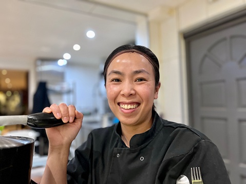 Woman chef working in an Asian kitchen