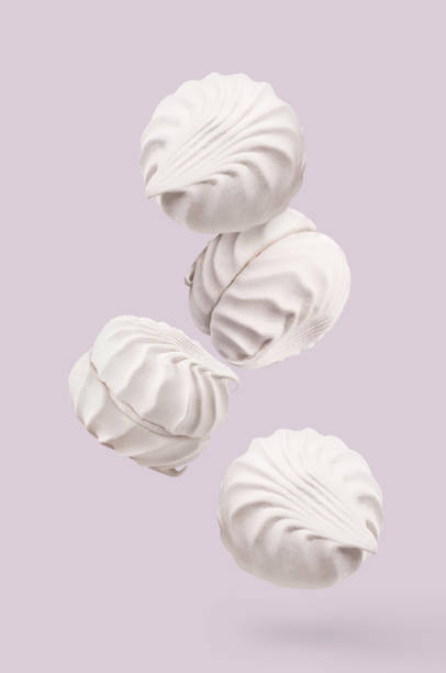 istock Flying delicious marshmallows on pastel background 1453177794
