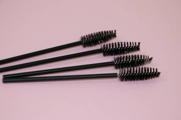 istock Black silicone brushes for eyelashes and eyebrows on a pink background. 1453183941