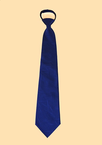 A vertical shot of a blue polyester necktie isolated on a yellow background.