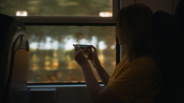 Woman shooting video of her trip inside the train.