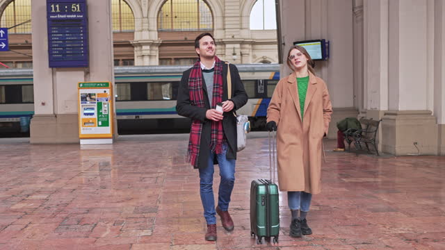 Couple exits the train station