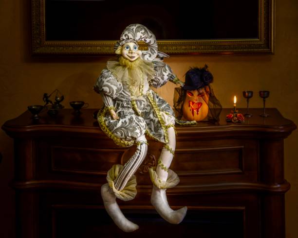 istock Halloween Harlequin doll next to a pumpkin 1453202749