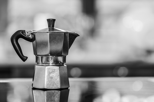 Italian coffee maker on rustic kitchen with unfocused background. coffee moment in the morning. copy-space