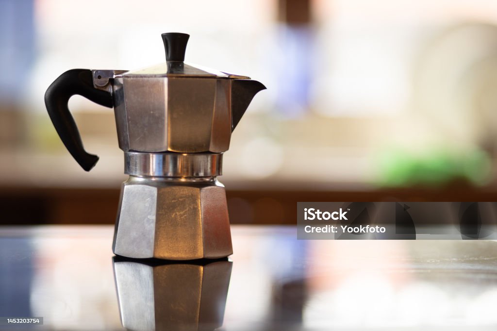 https://media.istockphoto.com/id/1453203754/photo/italian-coffee-maker-on-rustic-kitchen-with-unfocused-background-coffee-moment-in-the-morning.jpg?s=1024x1024&w=is&k=20&c=stECkHrDVuSkpnRywEhqZa3gI-FYBLWAQBU9tO1lDPY=