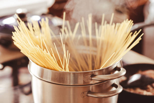 istock metal cauldron filled with hard paste and put on the fire and smoking. 1453203755