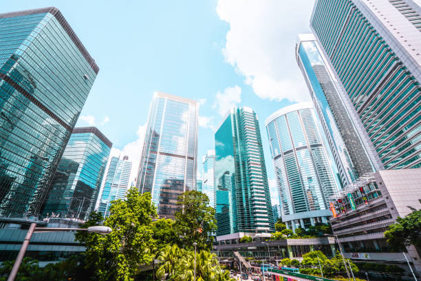 A low angle shot of tall buildings in Hong Kong. A low angle shot of tall buildings in Hong Kong. hong kong business district stock pictures, royalty-free photos & images