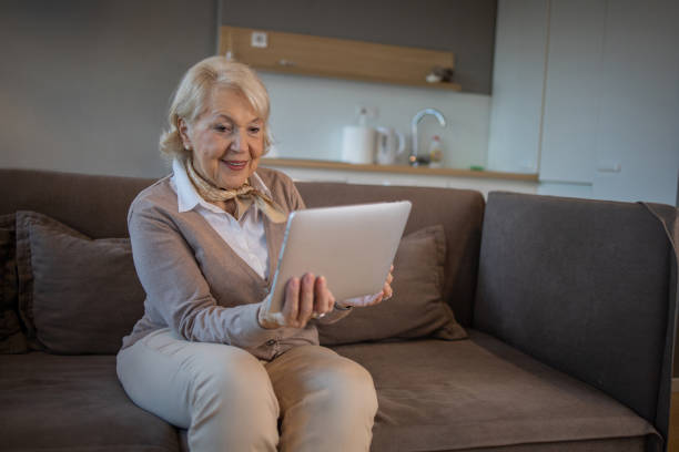 istock Cheerful  woman doing online shopping 1453209733