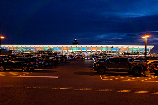 Dulles Airport, Washington DC USA Dec 1, 2022 The main terminal of the Dulles Airport at night seen from the parking lot at night.