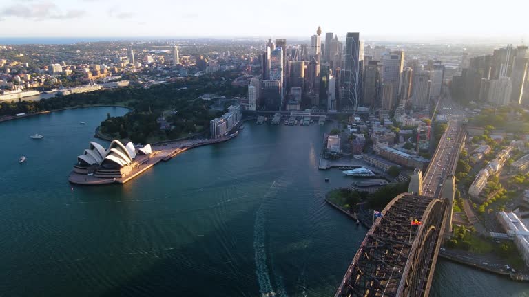 Aerial drone view of Sydney City and Sydney Harbour above Sydney Harbour Bridge in the late afternoon