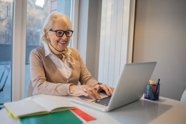 istock Senior woman working from home 1453217308