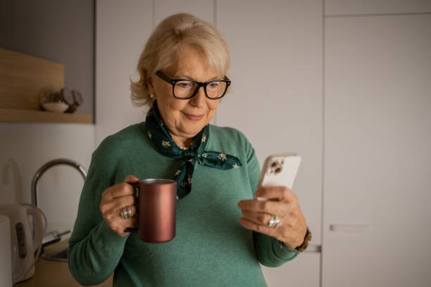 istock Happy senior woman using phone 1453218545