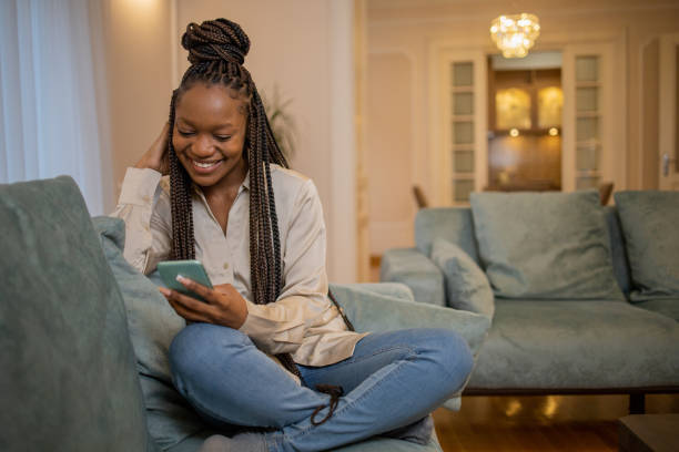 istock Happy young woman using phone 1453218559