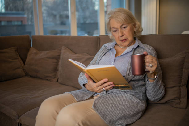 istock Woman relaxing and reading a book 1453219051