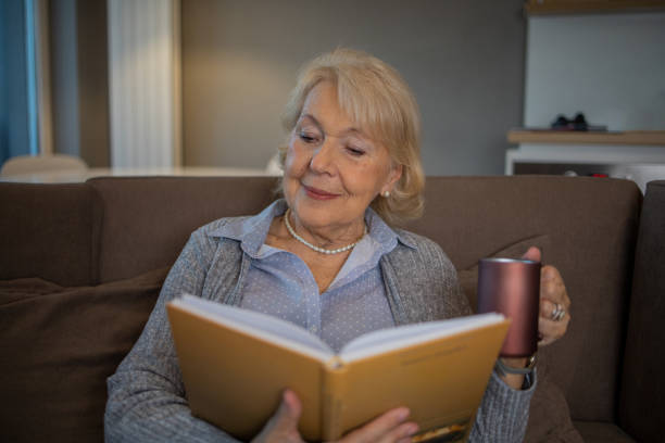 istock Woman relaxing and reading a book 1453219196