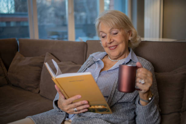 istock Woman relaxing and reading a book 1453219202