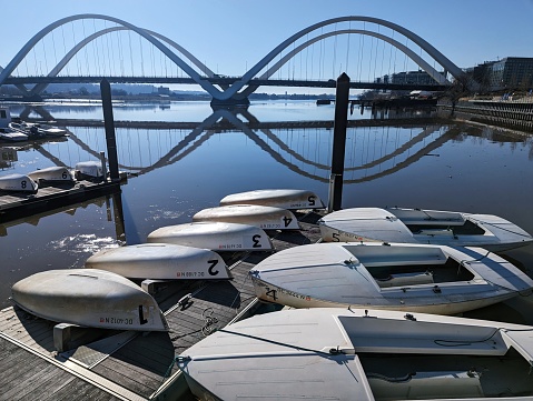 Washington, DC - December 29, 2022: Boats at the Diamond Teague Park pier, with the Frederick Douglass Memorial Bridge in the background