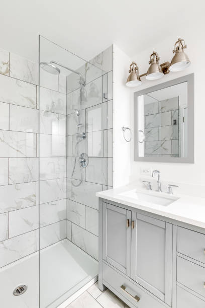 istock A bathroom with a grey cabinet and tiled shower. 1453223695