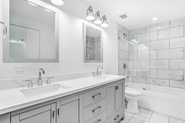 istock A bathroom with a grey cabinet and tiled shower and bathtub. 1453223697