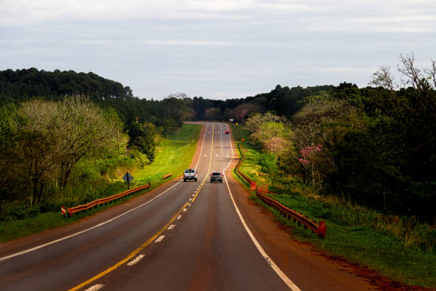 Pickup truck overtakes a car on Highway 12 in Misiones, Argentina Pickup truck overtakes a car on Highway 12 in Misiones, Argentina misiones province stock pictures, royalty-free photos & images