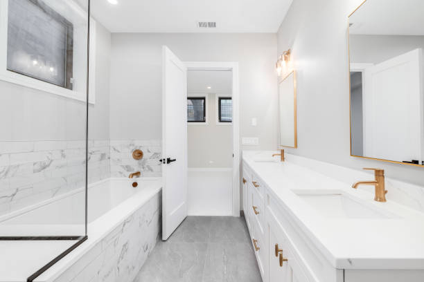 istock A white bathroom with gold hardware and faucets. 1453224566