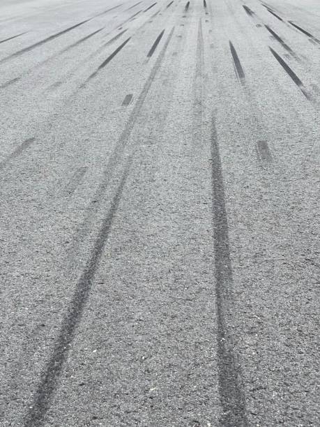 istock Many tire trails on asphalts 1453227775