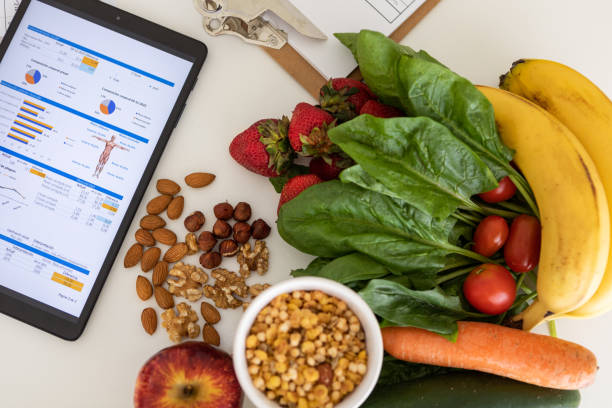 istock Digital nutritional program with heathy food and digital tablet charts 1453227790