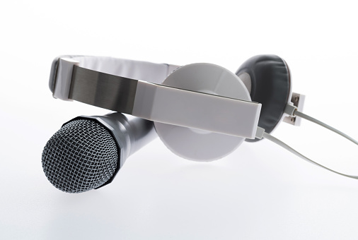 Microphone and headphones on white background.