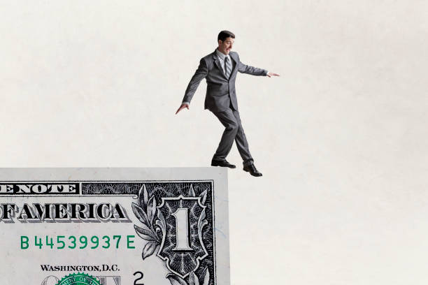 istock Man Stepping Off The Edge Of One Dollar Bill 1453233382