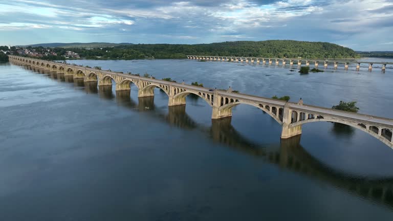 Two bridges reflect in water over river. Traffic between Columbia and Wrightsville PA. Route 30 and Route 462.