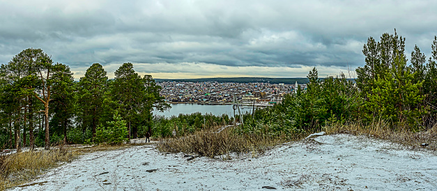 picturesque view of the city pond and the small Ural town of Sysert in the Middle Urals, near the city of Yekaterinburg at the beginning of winter