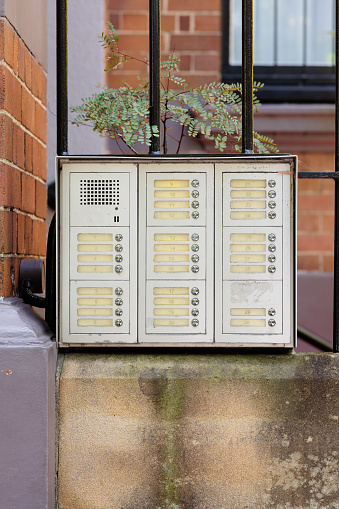 Metal access intercom in front of a building.