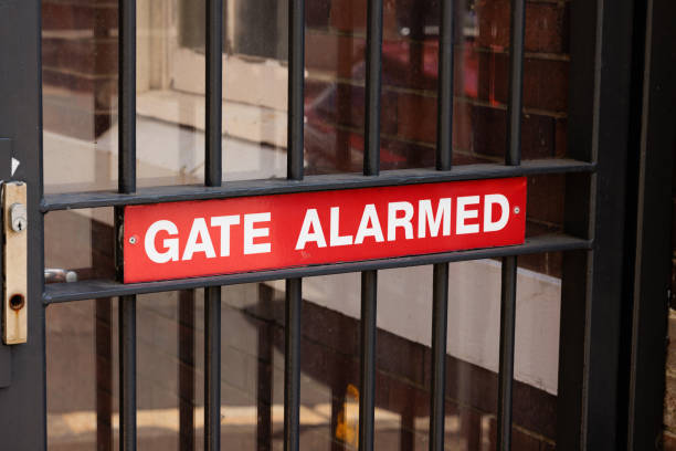 istock Gate alarmed sign on a metal gate 1453244035