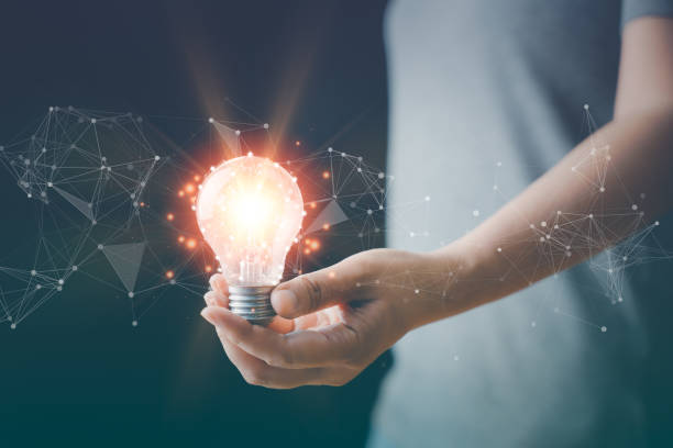 istock Hand with a light bulb. The idea of inspiration from online technology. innovation idea concept. Success business solution, creative and brainstorm symbol by glowing light. Knowledge aspiration. 1453245878