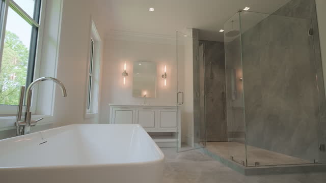 Modern Tiled Bathroom with Shower in modern home, real estate interior. Wide shot footage